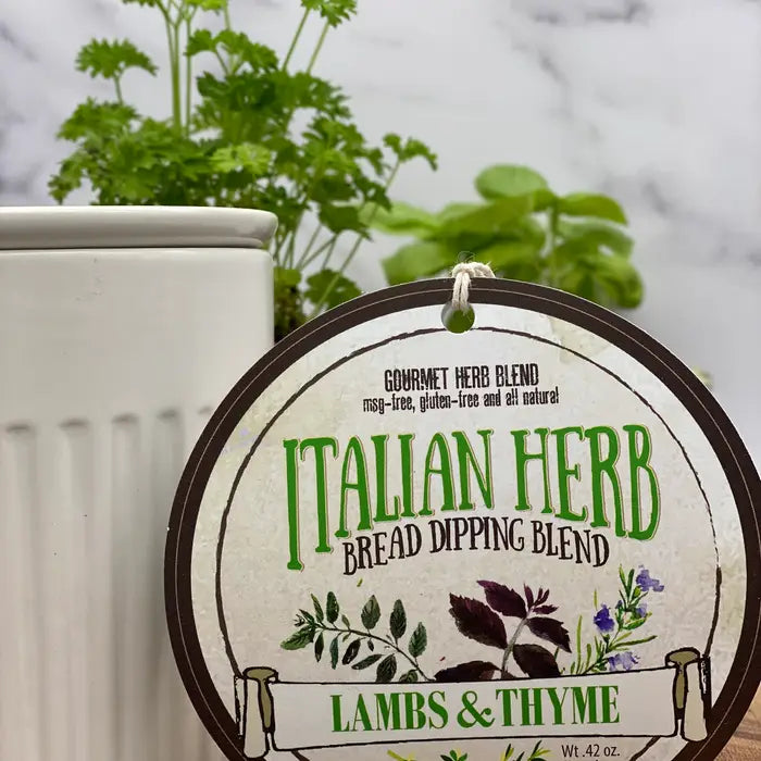 Italian Herb Bread Dipping Blend label with herbs in the background from Lambs & Thyme