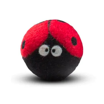 Red and black ladybug-shaped wool dryer ball on a white background