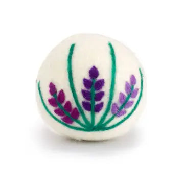 White wool dryer ball with purple and green floral design on a white background