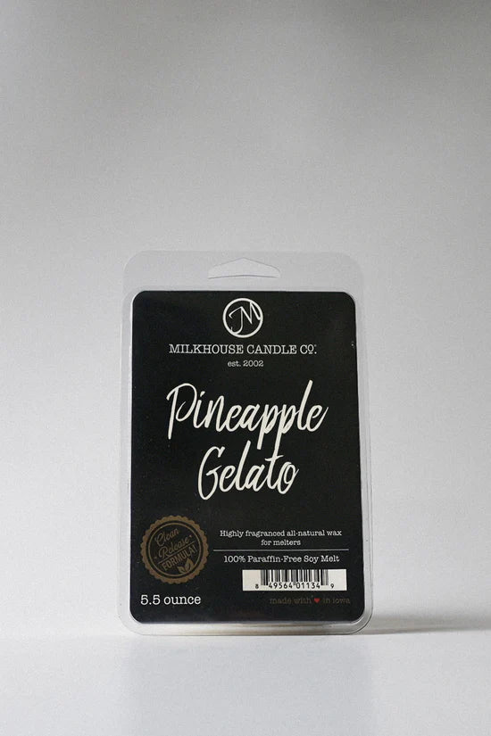 Packaged candle labeled 'Pineapple Gelato' by Milkhouse Candle Co. on a gray background