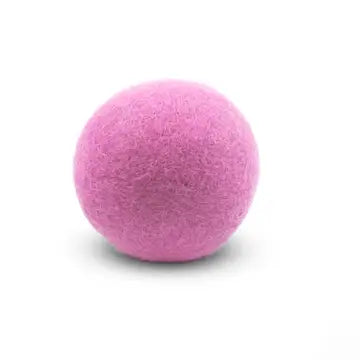 Pink wool dryer ball on a white background