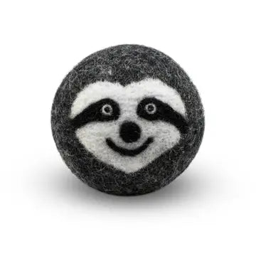 Felted wool dryer ball with a sloth face design on a white background