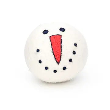 White wool dryer ball with a red triangle and black dots on a white background looks like a snowman face