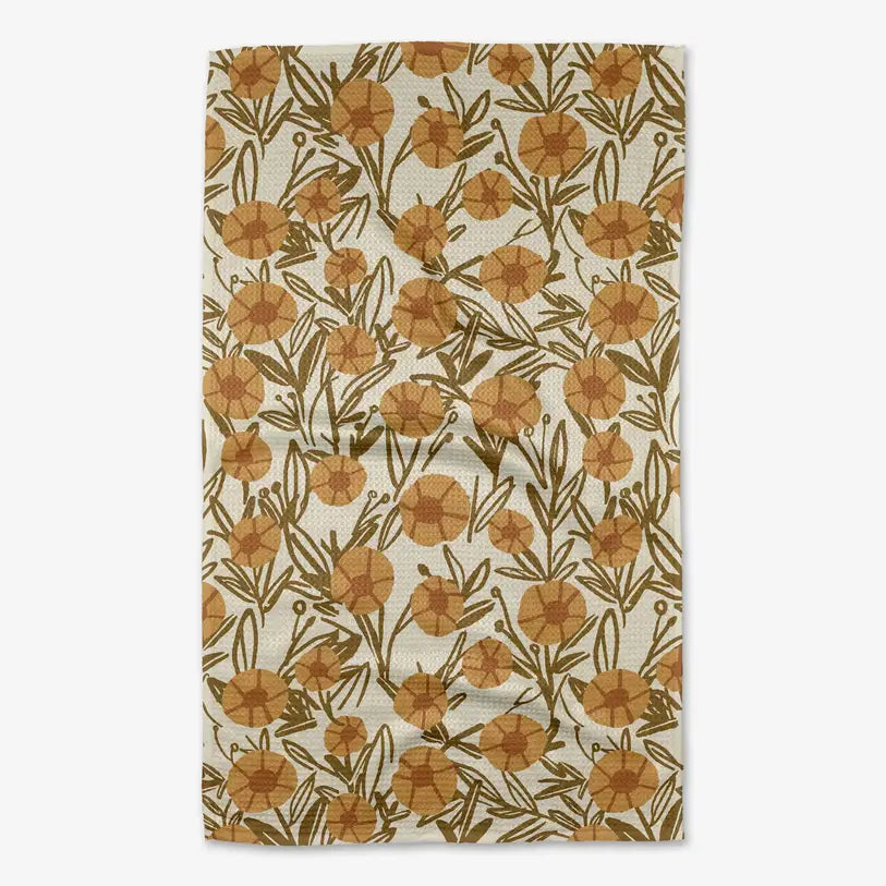 A rectangular tea towel  with a repeating pattern of mustard yellow flowers and olive green leaves on a cream background.
