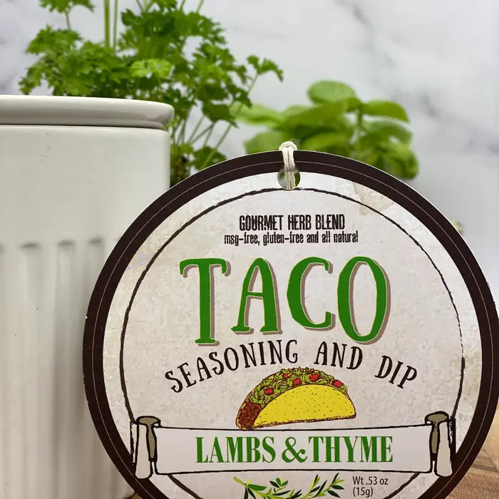 Taco seasoning and dip packaging with a plant in the background from Lambs & Thyme