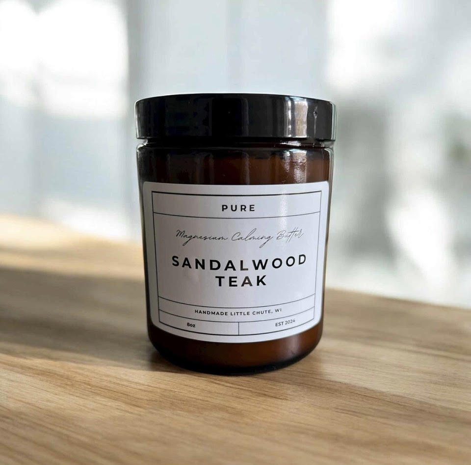 Jar of Sandalwood Teak product on a wooden surface with a blurred background