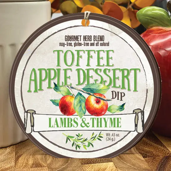 Toffee Apple Dessert Dip container with apples and autumn leaves in the background from Lambs & Thyme