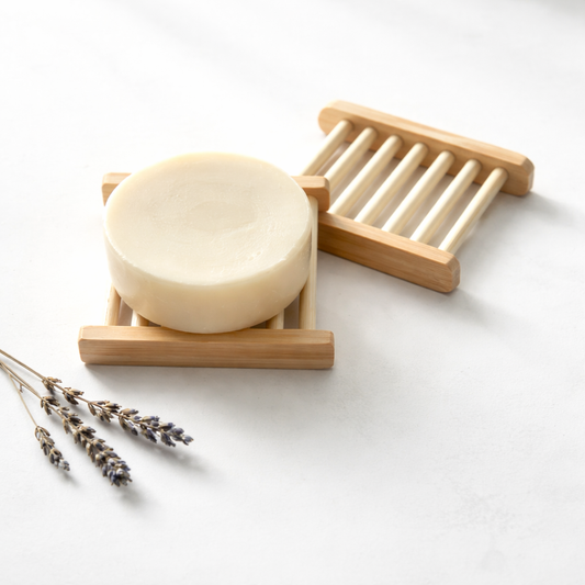 Bamboo Soap trays with bar of soap and a piece of lavender on a white background