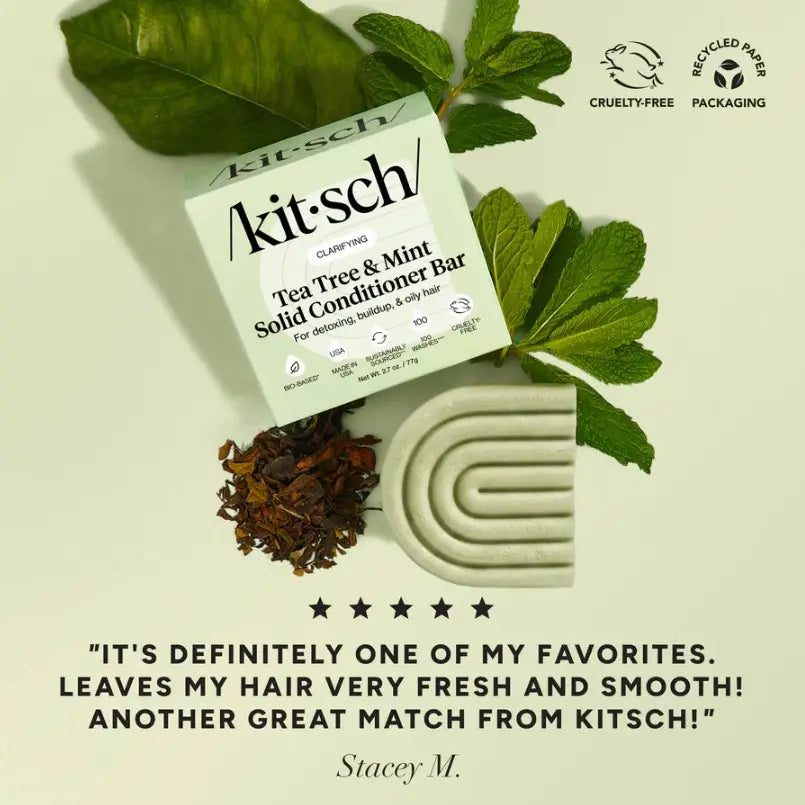 Kit-sch Tea Tree & Mint Solid Conditioner Bar with packaging and leaves on a light green background