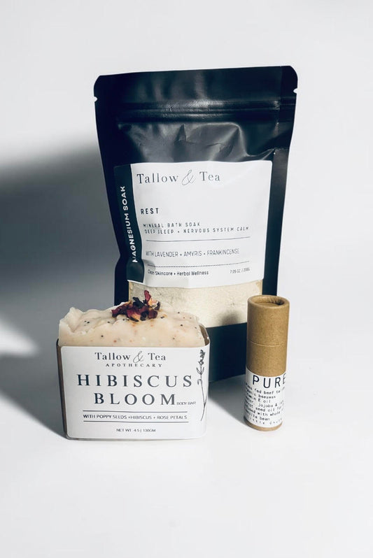 Tallow & Tea products including a bar of soap, packaging, and a small container on a white background