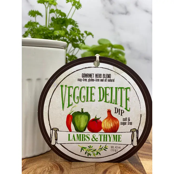Veggie Delite Dip container with herbs in the background from Lambs & Thyme