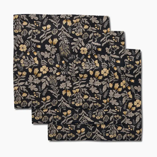 Set of three floral-patterned dishcloths on a white background