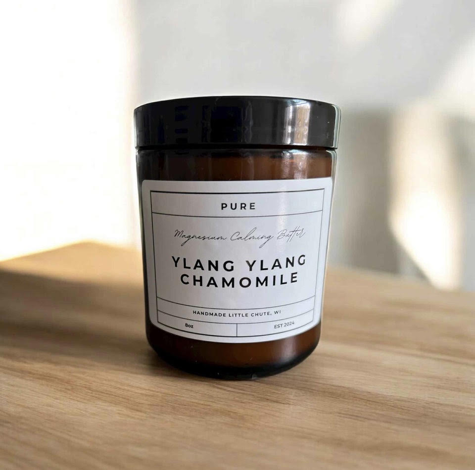 Magnesium Calming Butter  jar labeled 'Pure Ylang Ylang Chamomile' on a wooden surface with a blurred background