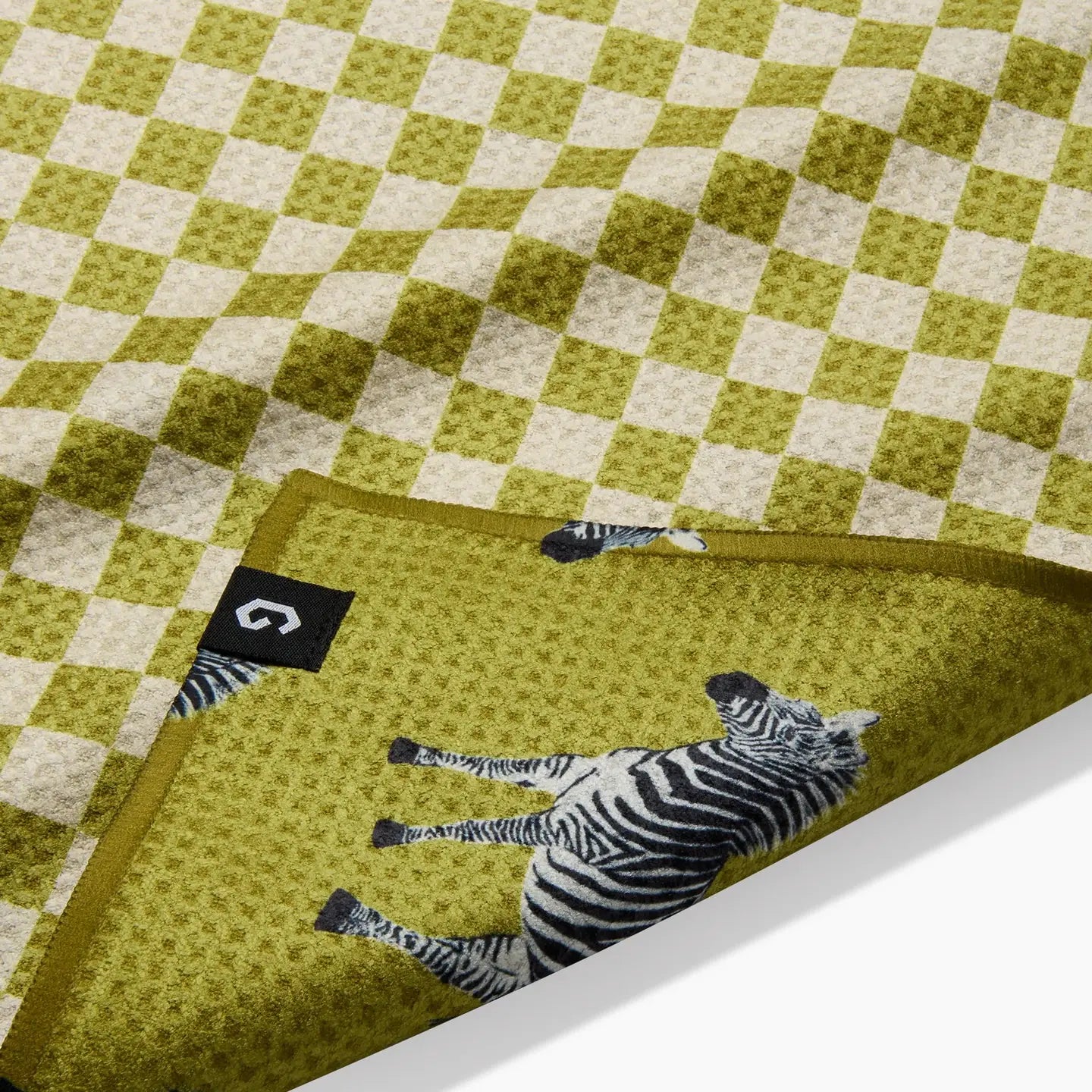 Green checkered Geometry Tea Towel with zebra pattern on a white surface